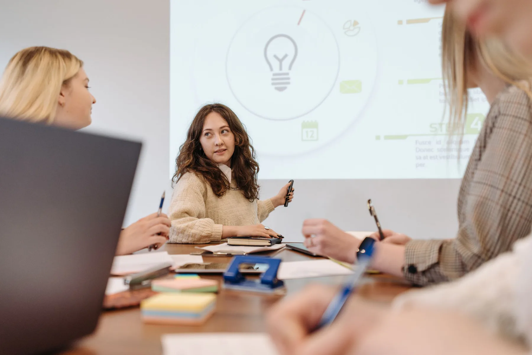 Team discussing a presentation in a meeting room.